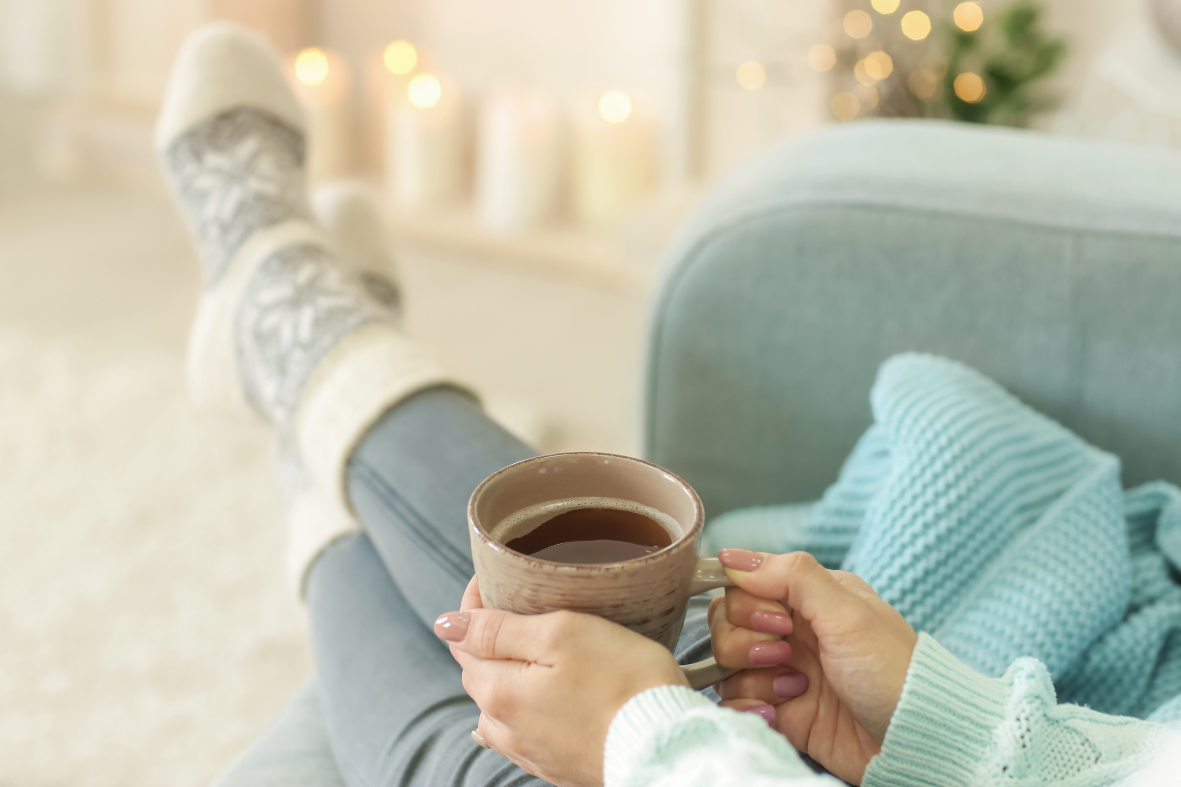 Woman with Holiday Socks Relaxing with a Cup of Tea